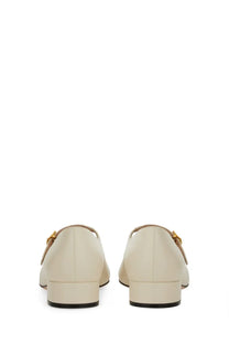 Bally women’s leather pump in white with cream-colored loafers and gold-tone buckle details