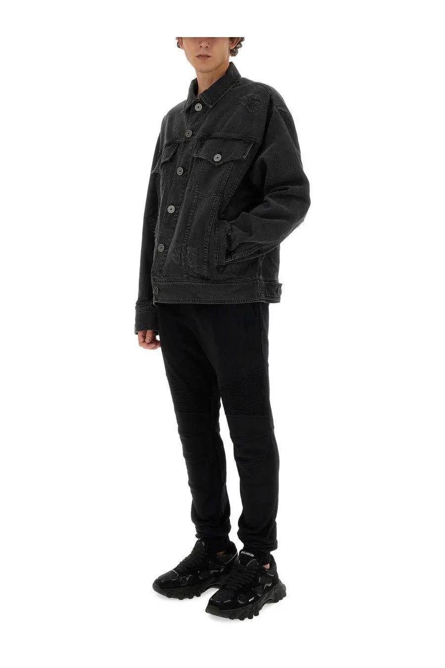 Balmain men’s black distressed denim jacket with button closures and flap pockets in denim material