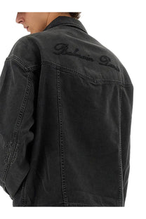 Balmain men’s black denim jacket with Balmain Paris embroidered in dark thread across the upper back view
