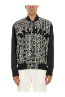 Balmain men’s multicolor bomber jacket with black and white pattern and bold Balmain lettering across the chest