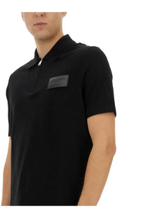 Balmain men’s black polo shirt with zipper placket and black leather patch on the chest
