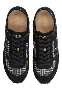 Balmain men’s racer sneaker black suede with bold white geometric pattern and gold tone branding accents