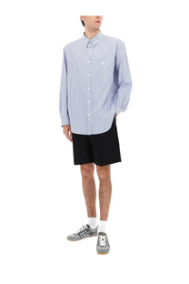 Balmain men’s light blue and white striped long-sleeve button-up shirt with small embroidered logo on left chest