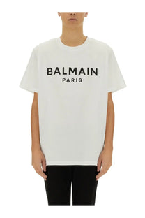 Balmain men’s white t-shirt featuring bold black paris logo lettering across the chest in cotton material