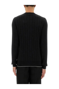 Balmain men’s black silk and cotton knit sweater with white trim on hem and cuffs in ribbed texture