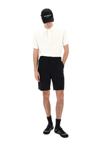 Black balmain paris cap with white embroidered logo paired with balmain men’s wool tailored shorts black