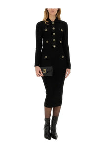 Black balenciaga leather clutch with gold-tone b logo paired with balmain women’s black knitted cardigan