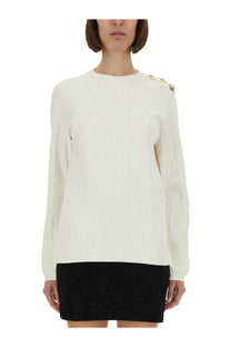 Balmain women’s cream-colored knitted long-sleeved sweater with decorative silver shoulder buttons in white