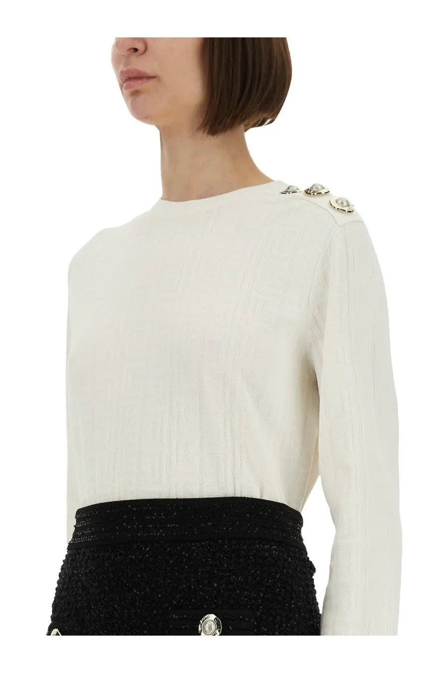 Balmain women’s cream-colored ribbed knit top with silver-toned decorative buttons on the shoulders