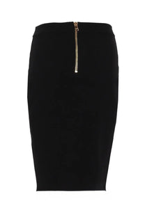 Back view of balmain women’s black midi pencil skirt with gold-toned zipper detail