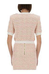 Balmain women’s soft pink tweed two-piece set with cropped jacket and skirt featuring white ribbed accents