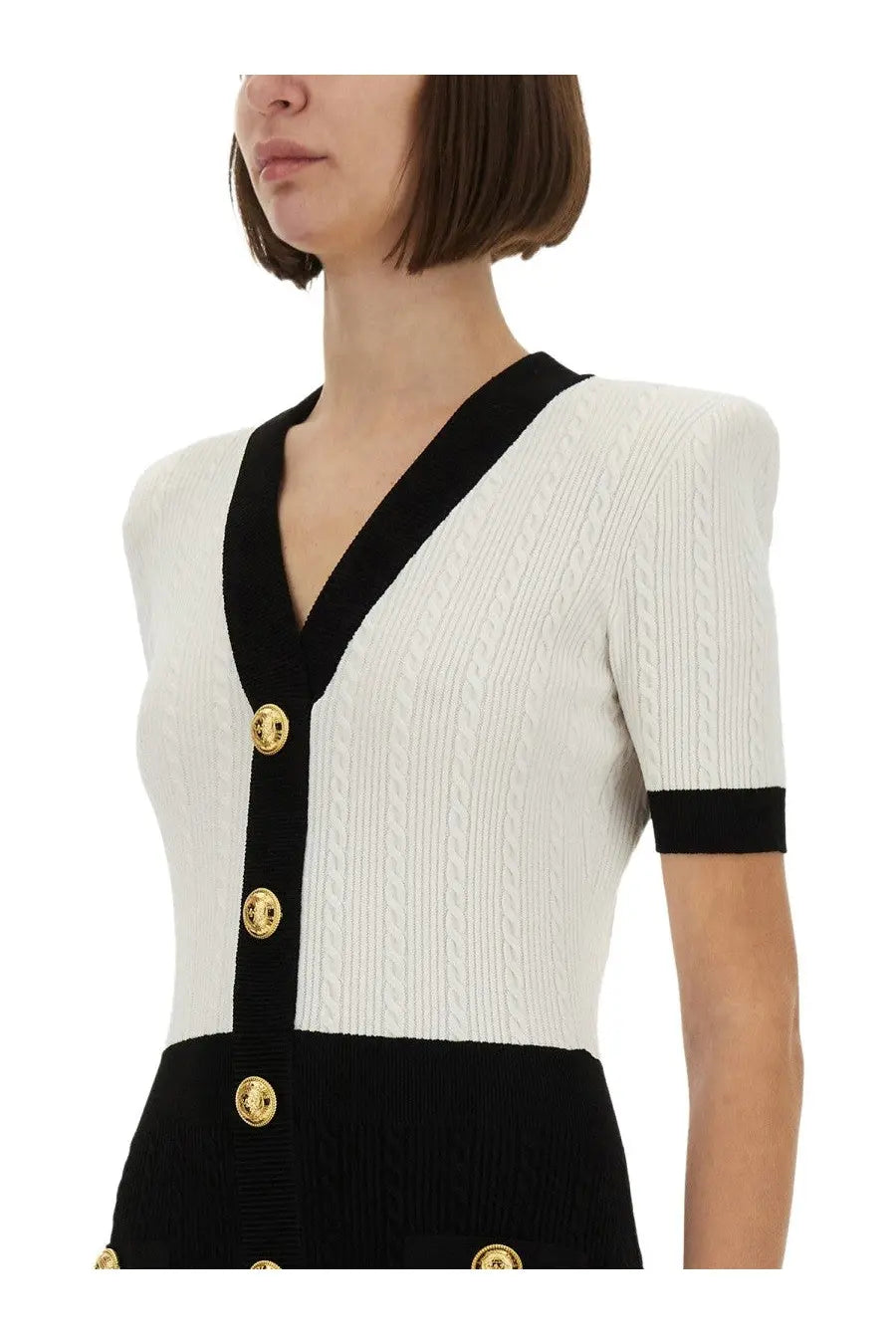 Balmain women’s two tone bodycon dress multicolor paired with a chic white and black cable-knit cardigan with gold medusa buttons