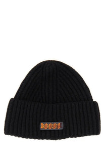 Black ribbed knit beanie hat with folded cuff and orange baracuta logo patch for men