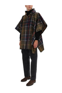 Barbour men’s poncho multicolor featuring a dark green black and red plaid pattern with a hood