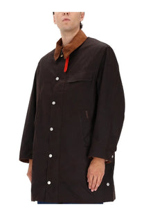 Barbour men’s waxed cotton jacket brown with black button-up coat, brown corduroy collar, and white buttons
