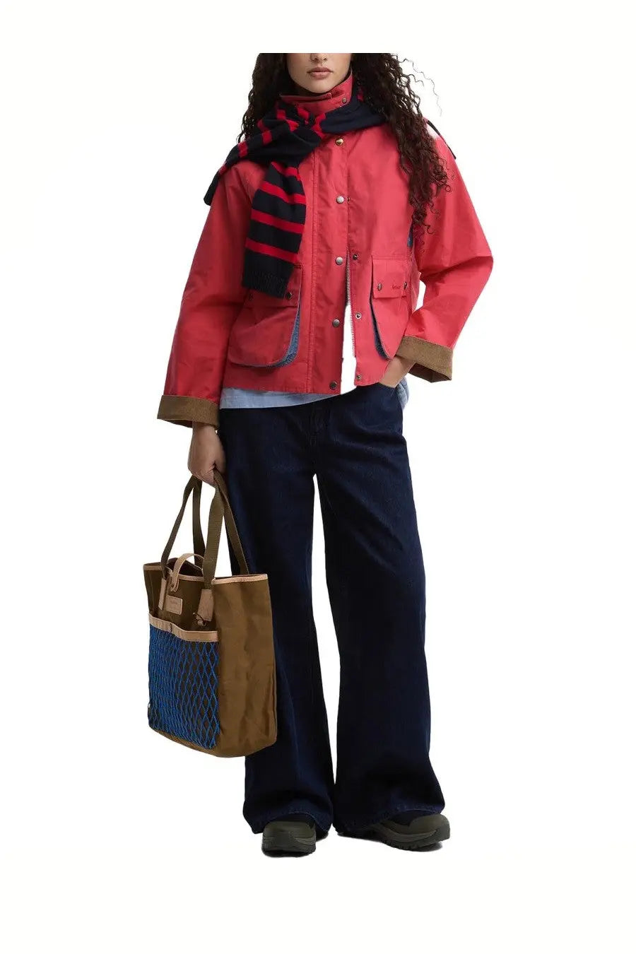 Brown and blue mesh tote bag with tan leather handles and front pocket for casual and beach use