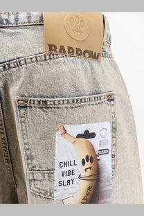 Light-wash barrow men’s cotton jeans with brown leather brand tag and paw print logo on the back waistband