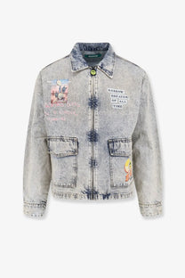 Light-wash blue barrow men’s denim jacket with faded tie-dye patterns and cartoon patches on chest pockets