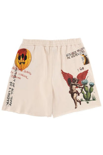 Barrow unisex cream-colored sweat shorts with graffiti-style smiling pumpkin and angel figure near cacti print