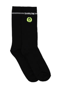 Black Barrow unisex crew socks with neon green pixelated smiley face and white lettering on the front side