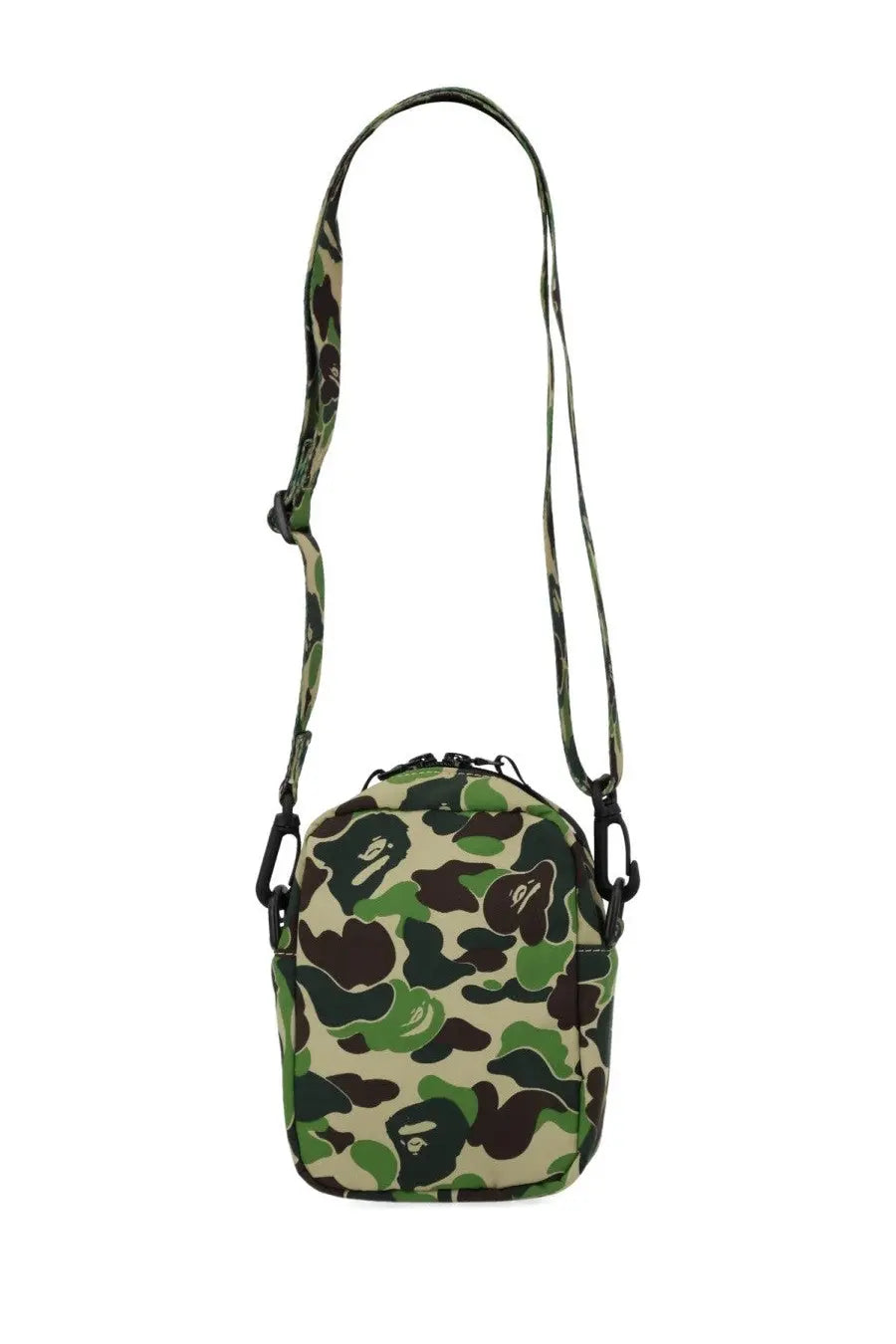 A camouflage-patterned crossbody bag with a repeating ape face design in shades of green, brown, and beige.