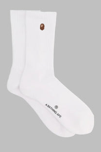 A bathing ape men’s white crew socks with brown embroidered ape face logo on cuff and black branding near heel