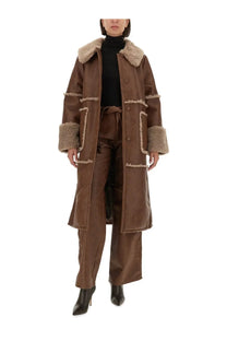Brown shearling-lined coat with plush light beige fur trim on collar and cuffs paired with baum und pferdgarten nadene pants brown