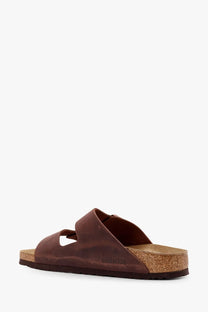 Brown leather birkenstock unisex arizona sandal with cork footbed and rubber sole shown from the back side