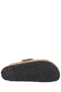 Tan suede birkenstock unisex mule loma brown clog with black rubber sole and wavy tread pattern viewed from the back