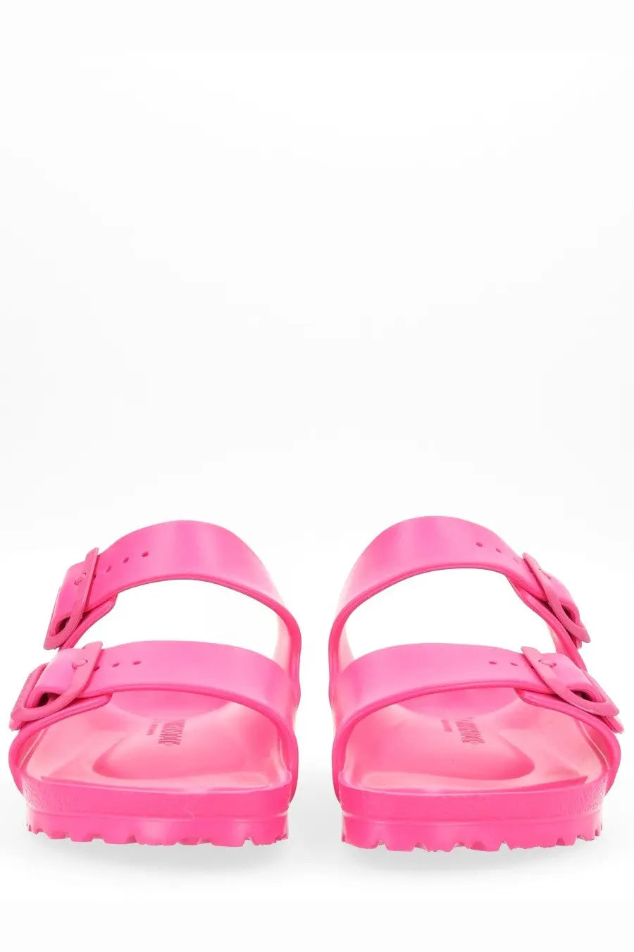 Bright pink glossy Birkenstock unisex Arizona rubber sandals with two adjustable straps and buckle closures