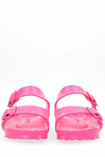 Bright pink glossy Birkenstock unisex Arizona rubber sandals with two adjustable straps and buckle closures