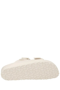 Cream-colored birkenstock unisex sandal arizona with two adjustable straps and textured rubber sole