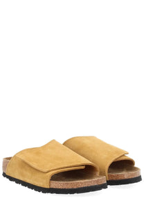 Tan suede birkenstock unisex sandal solana brown slide with cork footbed and black rubber sole visible from the back