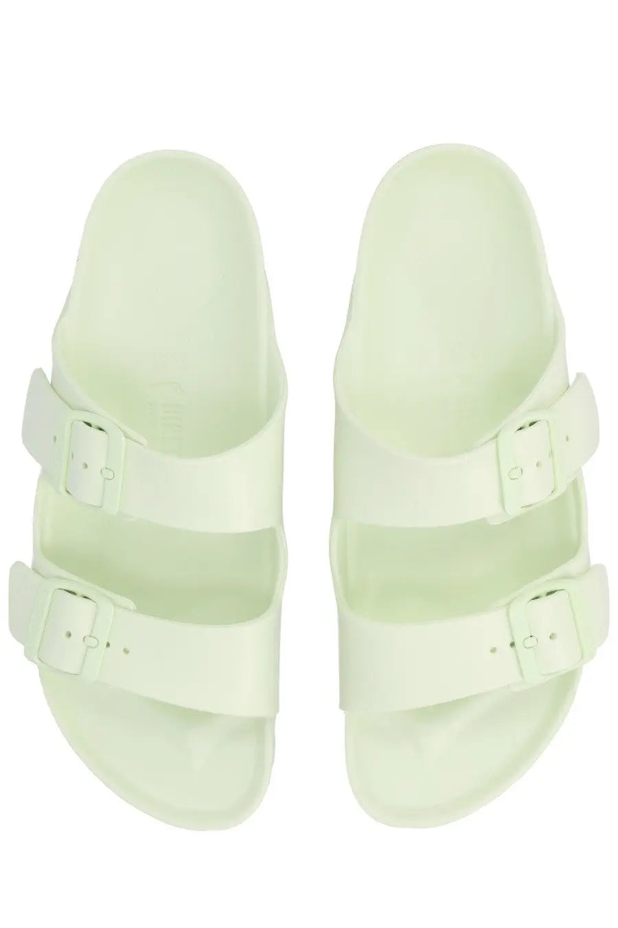 A pair of light mint green birkenstock unisex sandals with two adjustable straps and matching buckle closures
