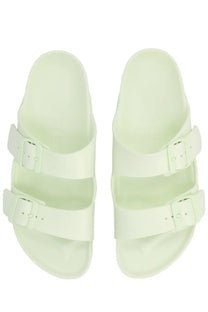 A pair of light mint green birkenstock unisex sandals with two adjustable straps and matching buckle closures
