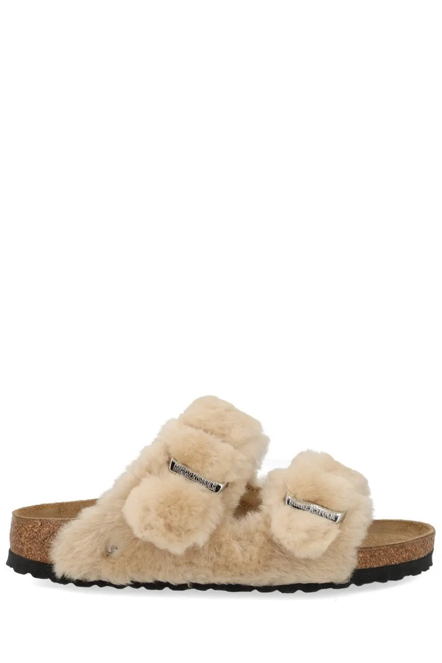 Beige birkenstock women’s arizona slide sandals with shearling-lined fluffy straps and silver buckle accents