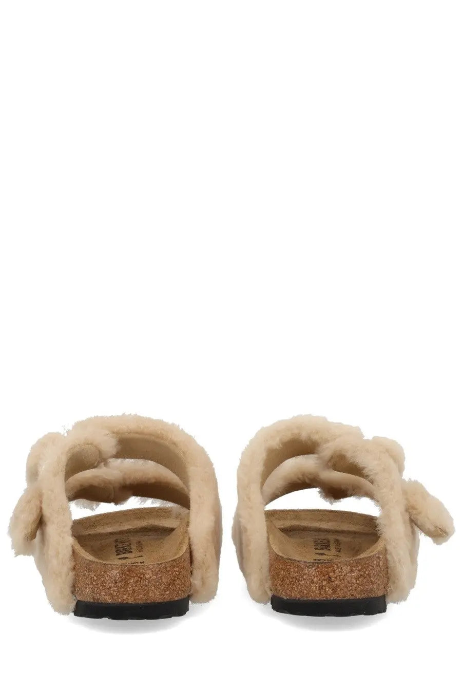 Beige birkenstock women’s arizona big buckle slide sandals with shearling lining cork footbed and black rubber sole