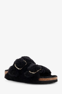 Birkenstock women’s arizona big buckle teddy sandals in black with fuzzy slip-on upper, gold buckle straps, and cork footbed