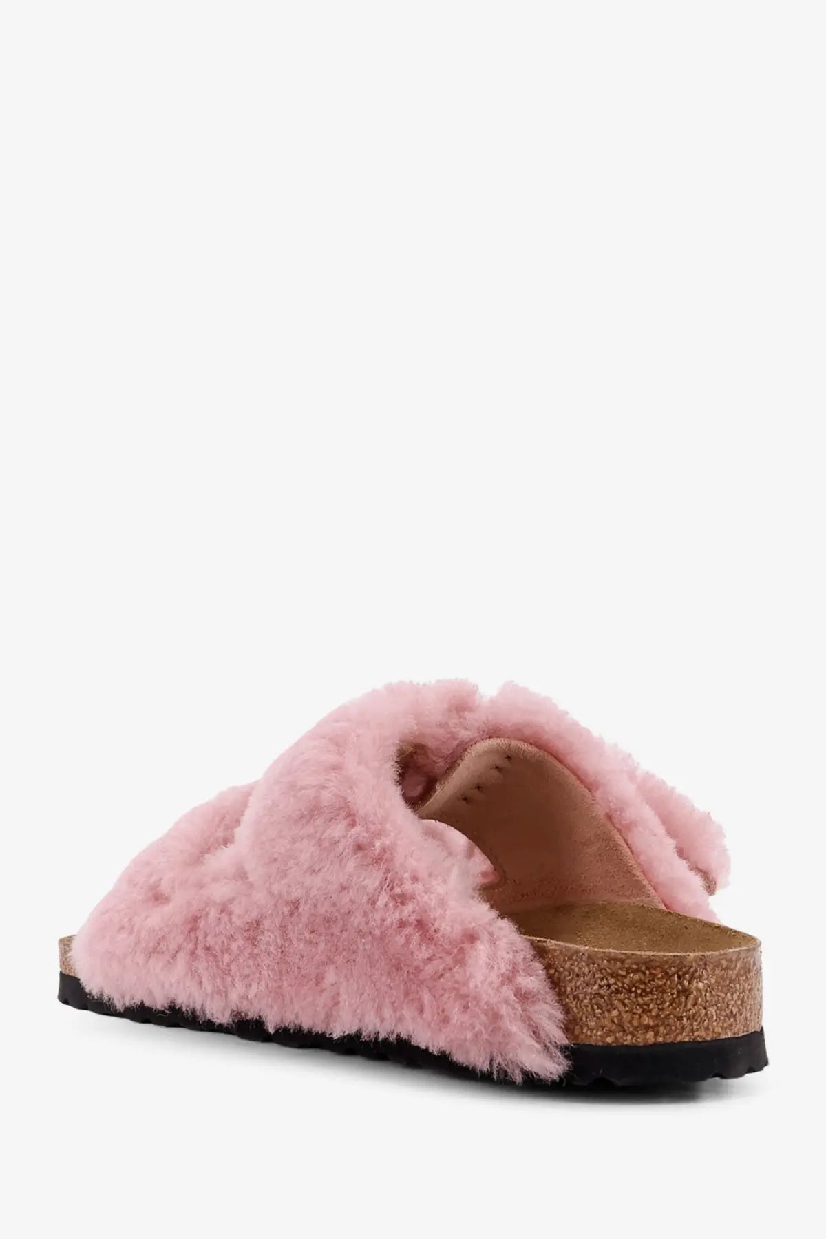 Birkenstock women’s arizona slide sandal in pink fluffy sheepskin with cork footbed and black rubber sole