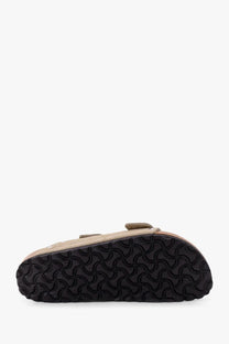 Beige suede birkenstock women’s arizona clog sandal with black rubber sole featuring a distinctive wavy pattern