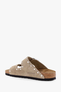 Beige suede birkenstock women’s arizona sandals with silver-toned studs along the straps in brown