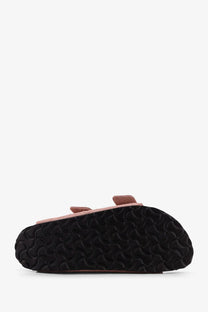 Pink suede birkenstock women’s arizona clog sandal with black rubber sole featuring signature wave pattern