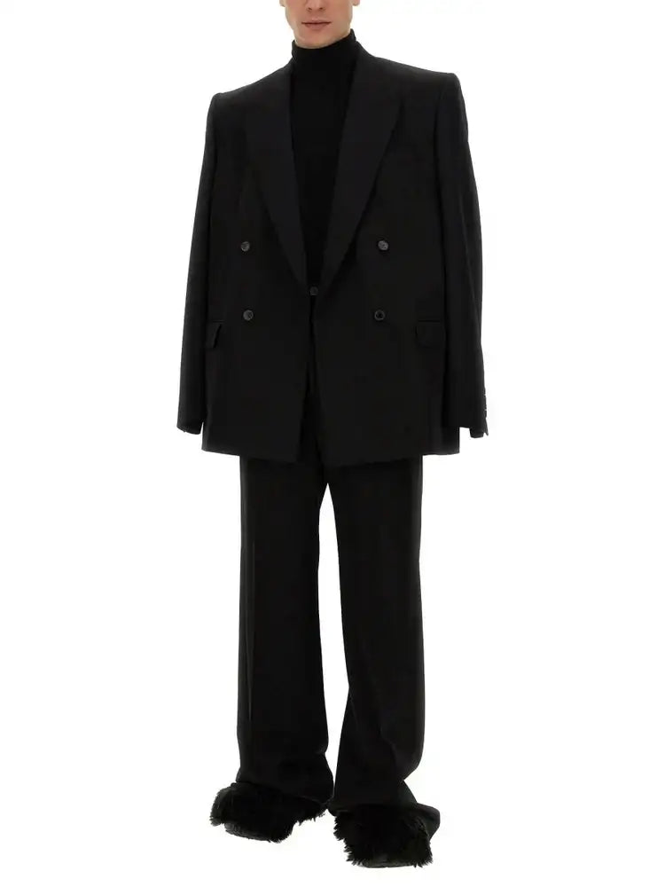 Black double-breasted blazer with structured shoulders and matte finish.