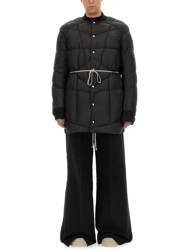 Black quilted puffer jacket with a high collar, front button closure, and matching drawstring belt.
