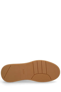 Back view of boss men’s baltimore tenn sneaker featuring a tan rubber sole with minimalist design and embossed logo