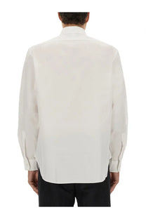A crisp white BOSS men’s Beckham dress shirt with long sleeves classic collar and neatly folded cuffs