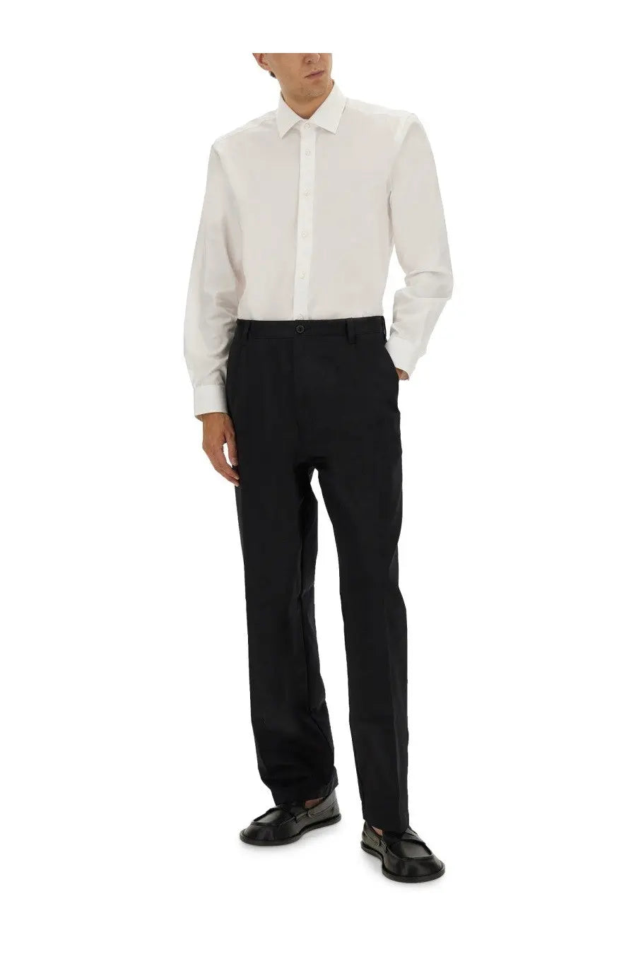 A crisp white BOSS men’s Beckham Boss dress shirt with classic collar and button-down front paired with black trousers