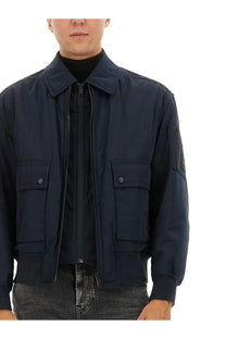 BOSS men’s bomber jacket in navy blue nylon with two front flap pockets and a zippered sleeve pocket