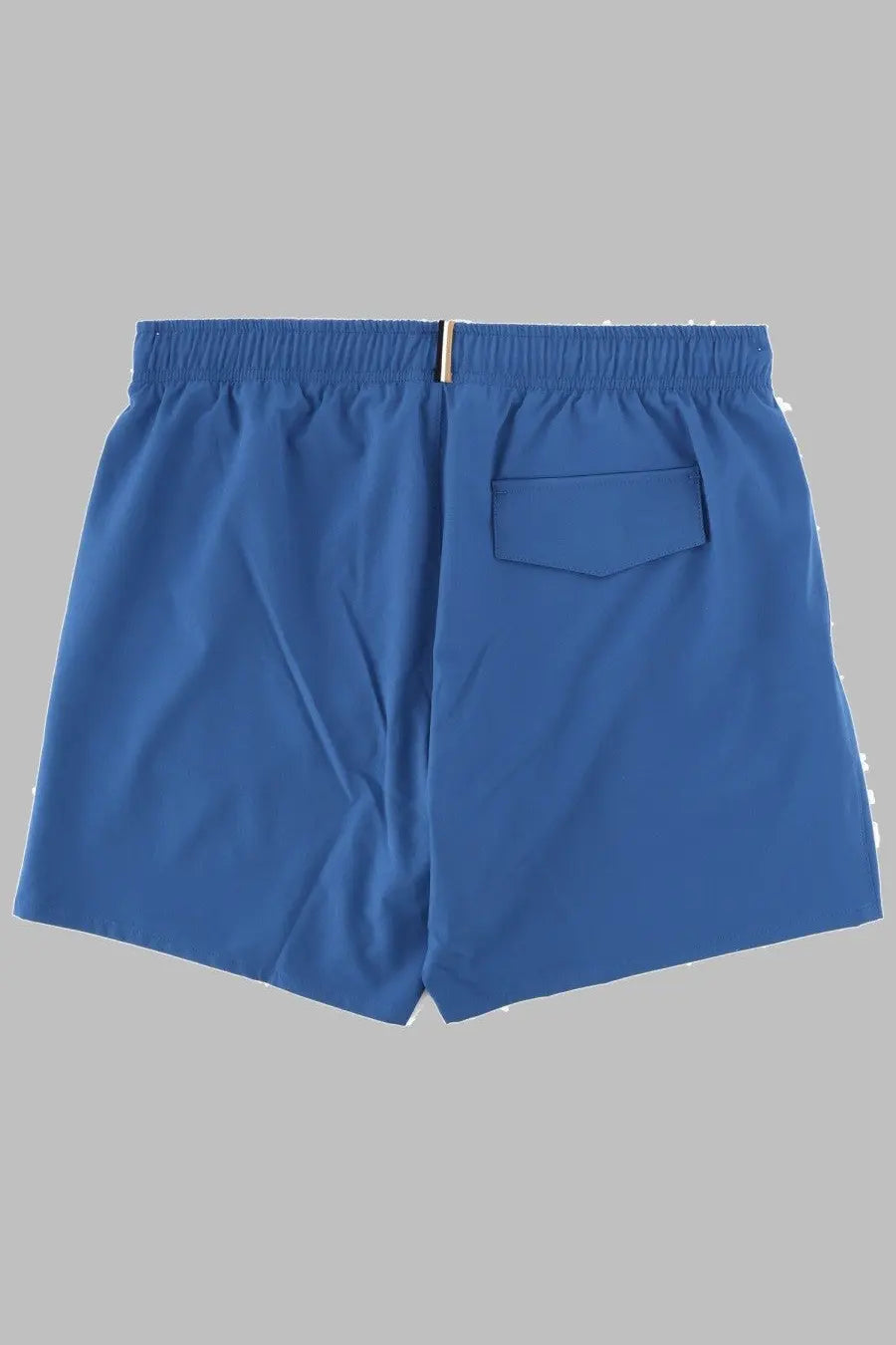 Boss men’s blue swim trunks with elastic waistband and single back pocket shown from the back side