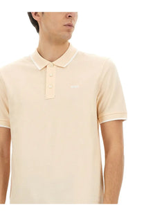 Beige BOSS men’s cotton polo shirt with white collar and sleeve trim designed for casual wear